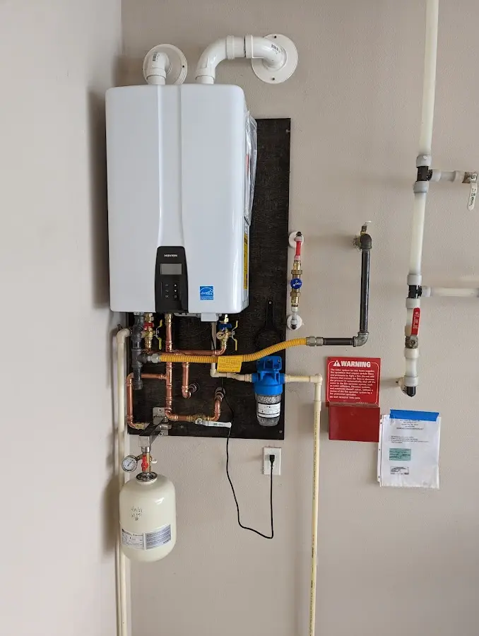 Professional plumber installing copper piping in a New Brunswick home